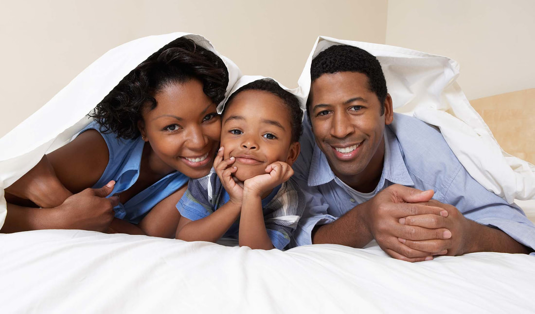 Smiling African American on their bed - Best Insurance Rates in Oklahoma City, OK 73170